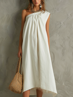 Vestido maxi blanco minimalista con un solo hombro y ambiente de resort